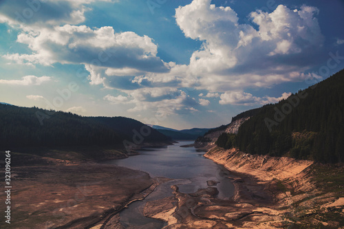 Landscape view of a river surrounded by forest and clouds