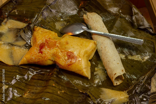 Nacatamal typical Nicaraguan food, corn, meat, butter, potatoes, onion, wrapped banana leaf photo