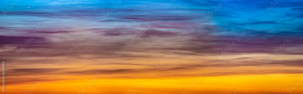 Panorama of beautiful colorful clouds in the sunset sky