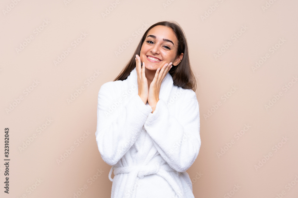 Young girl in a bathrobe over isolated background with surprise facial expression Young girl in a bathrobe over isolated background with surprise facial expression