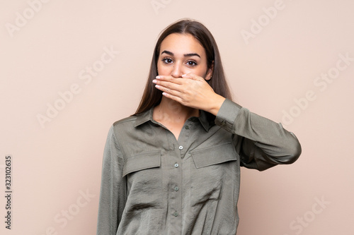 Young girl over isolated background covering mouth with hands