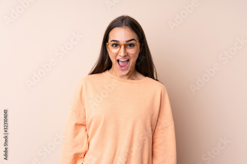 Young girl over isolated background with surprise facial expression © luismolinero