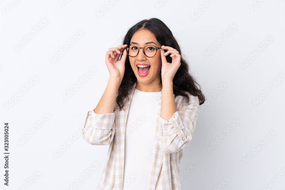 Mixed race woman over isolated white background with glasses and surprised Mixed race woman over isolated white background with glasses and surprised