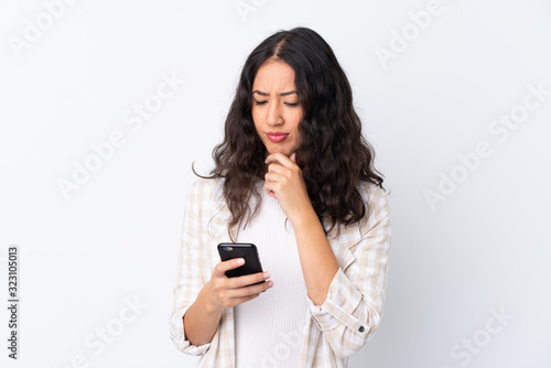 Mixed race woman over isolated white background thinking and sending a message