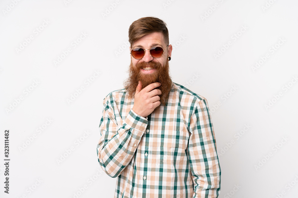 Redhead man with long beard over isolated white background with glasses and smiling Redhead man with long beard over isolated white background with glasses and smiling