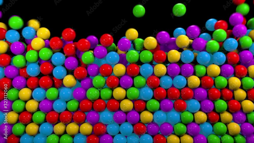 Colorful glossy balls falling from top. Kids plastic shiny toys, abstract motion background Colorful glossy balls falling from top. Kids plastic shiny toys, abstract motion background