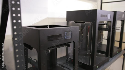 3D technology wide shot printers that print plastic parts in the factory photo