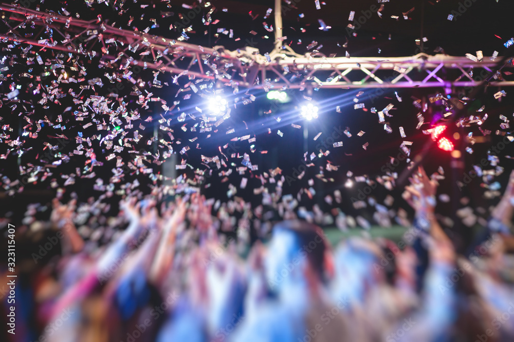 Colourful confetti explosion fired on dance floor air during a concert ...