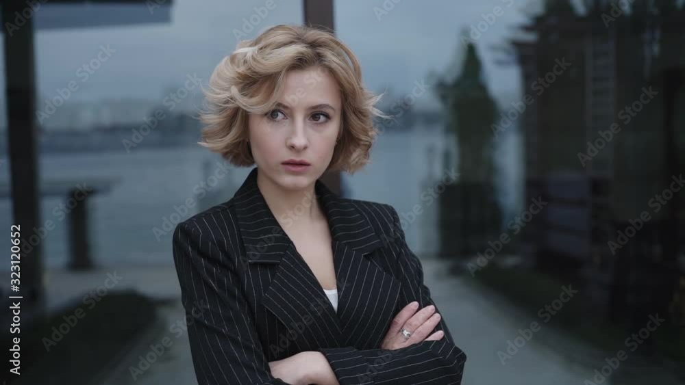 Portrait of serious lady crossing hands at camera outdoors Portrait of serious lady crossing hands at camera outdoors