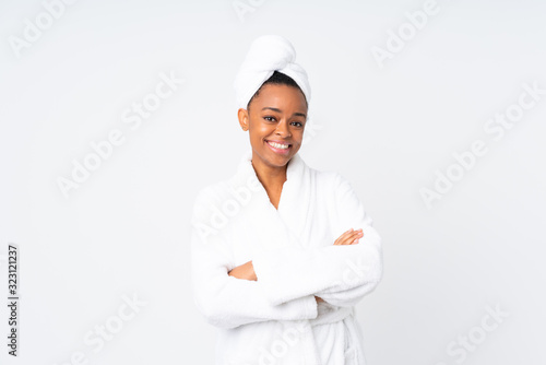 African american woman  in a bathrobe over isolated background laughing