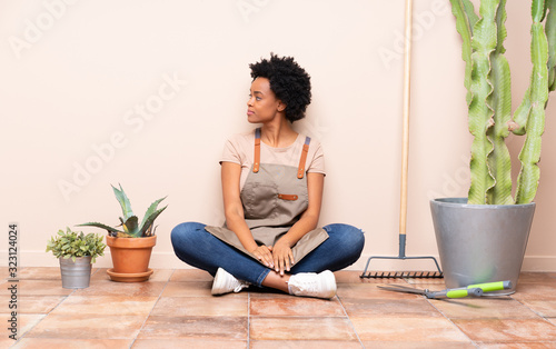 Gardener woman sitting on the floor in lateral position