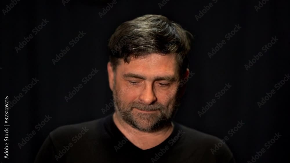 senior man looking shyly into the camera senior man looking shyly into the camera