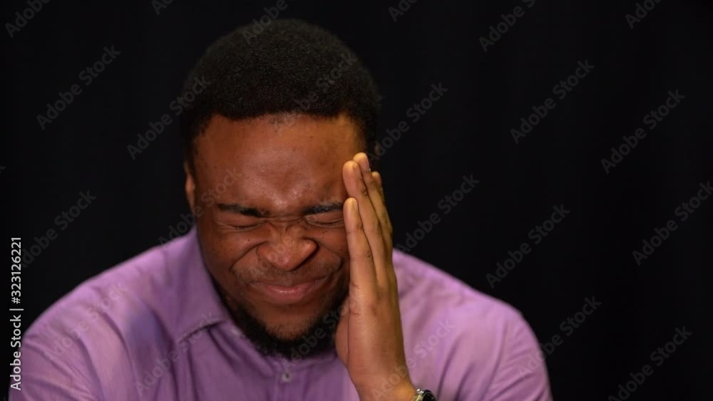 young african man suffering from headache young african man suffering from headache