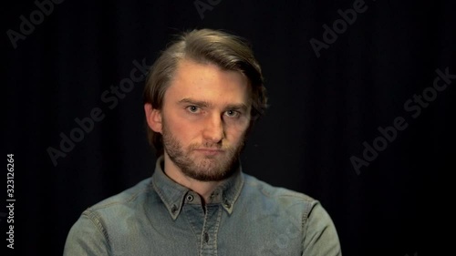 standing man looking unobtrusively into the camera photo