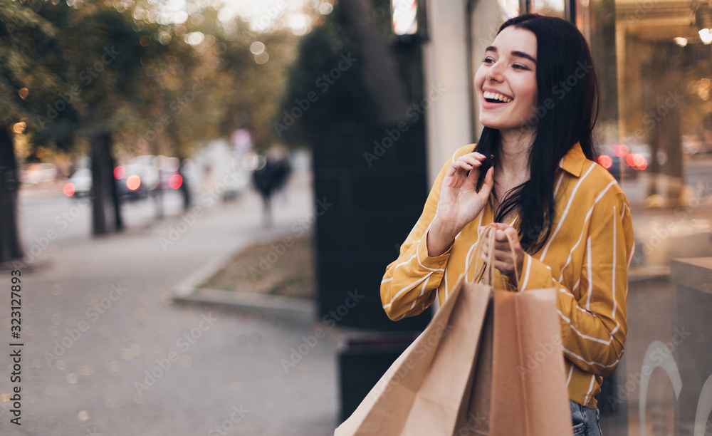 Young smiling woman shopping and relax near street cafe