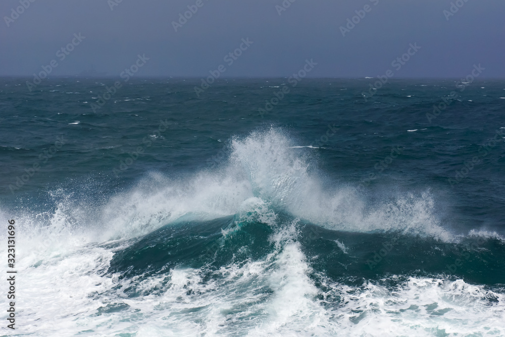 waves crashing on the open sea, stormy weather