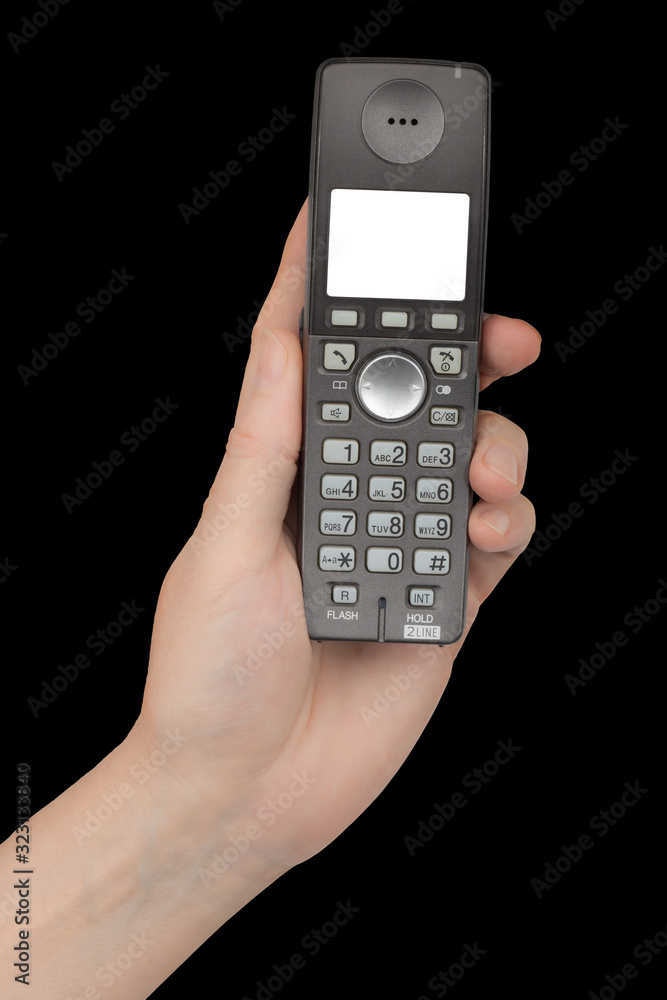 Female hand holds a phone with a white blank screen, isolated on black background Female hand holds a phone with a white blank screen, isolated on black background