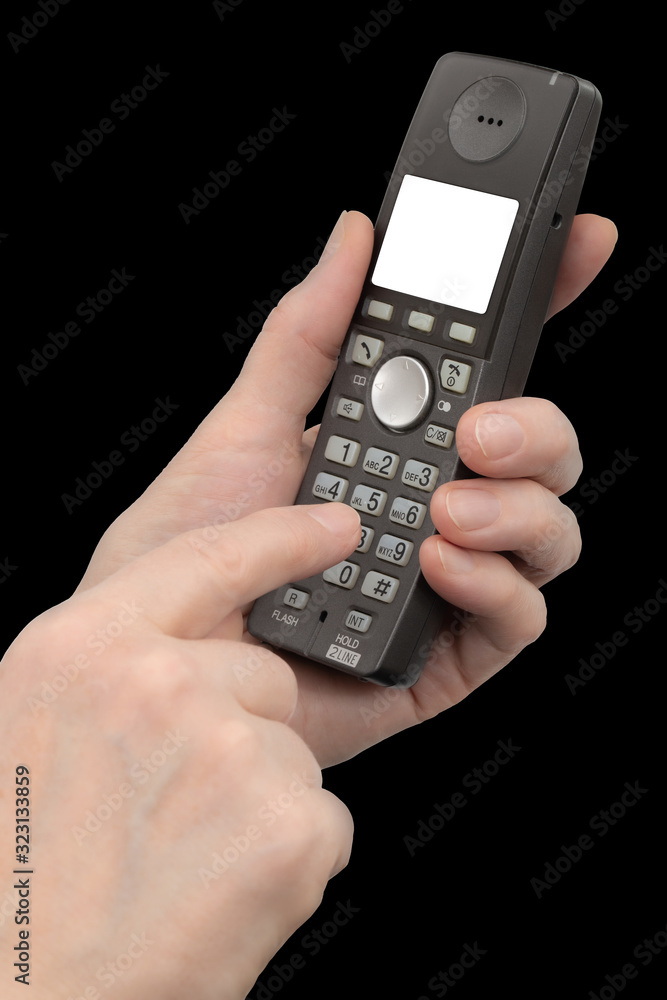 Female hand holds a phone with a white blank screen, isolated on black background Female hand holds a phone with a white blank screen, isolated on black background