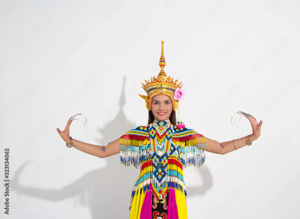Fototapeta premium Young lady wearing Thai Tradition southern costume and put headdress on her head,showing basic pattern folk dance,black shadow reflection on white background