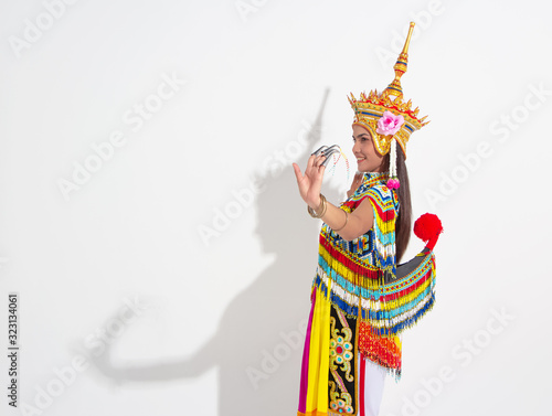 Young lady wearing Thai Tradition southern costume and put  headdress on her head,showing basic pattern folk dance,black shadow reflection on white background photo