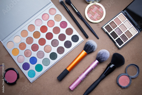 Makeup studio with all the accessories such as shadow palettes, concealers, makeups, eyeliners, brushes, lipstick and highlighter