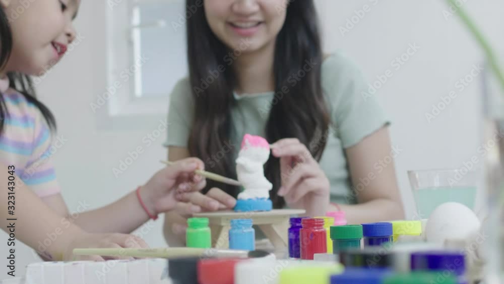 Sister and sister Have fun colouring plaster To decorate for the occasion of celebration Thanksgiving Day. Easter Day Concept. Sister and sister Have fun colouring plaster To decorate for the occasion of celebration Thanksgiving Day. Easter Day Concept.