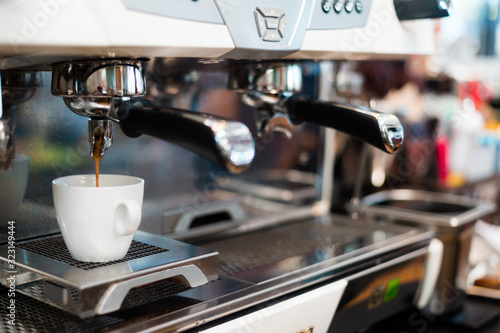 black coffee in white cup on coffee maker