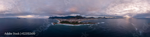 Rio de Janeiro, Brazil, with Arpoador rock and Copacabana fort in the foreground and wider cityscape in the background against an overcast slightly coloured sunrise sky. Aerial 360 degree panorama