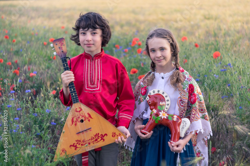 Obraz na płótnie Portrait of a boy and a girl in the field