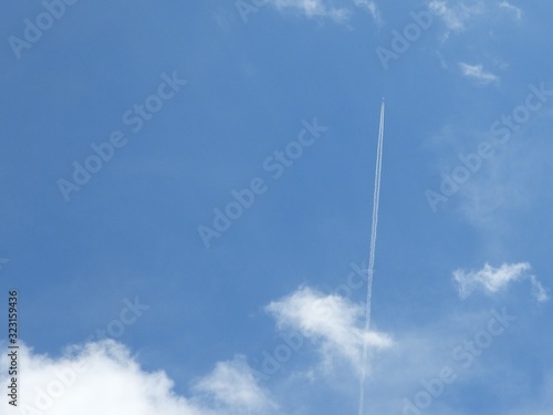 airplane in blue sky in Brazil with smoke trail 4