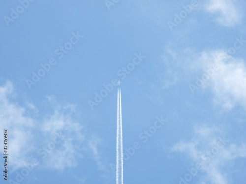 airplane in blue sky in Brazil with smoke trail 3