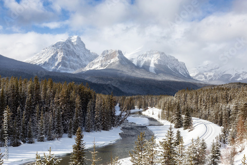 Fototapeta Naklejka Na Ścianę i Meble -  Banff National Park, Alberta, Canada. Iconic View of Morant's Curve with Canadian Rocky Mountains in the background during a vibrant winter day.
