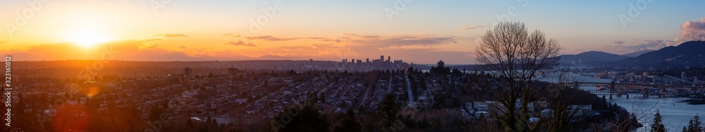 Fototapeta premium Burnaby, Greater Vancouver, British Columbia, Canada . Beautiful Panoramic View of the city from the top of the hill during a colorful winter sunset.