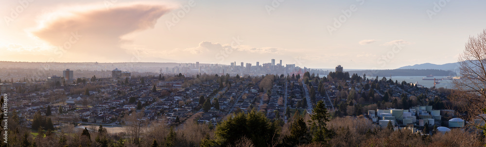 Obraz premium Burnaby, Greater Vancouver, British Columbia, Canada . Beautiful Panoramic View of the city from the top of the hill during a colorful winter sunset.