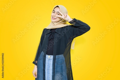 Portrait of Asian woman with cute face on yellow background
