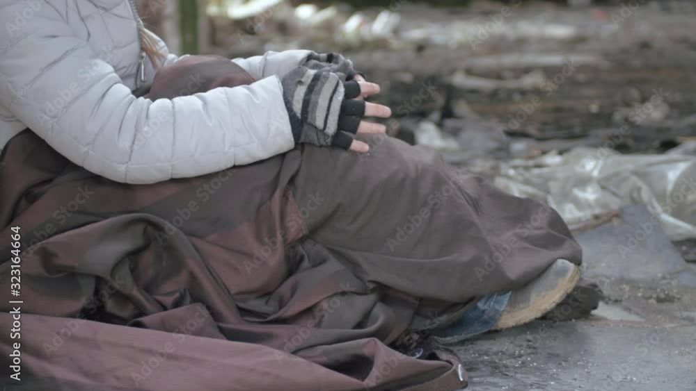 Homeless person wrapped in blanket in abandoned derelict building Homeless person wrapped in blanket in abandoned derelict building