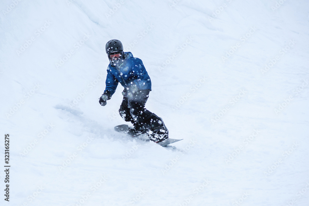People are having fun in downhill skiing and snowboarding in the middle of snowfall People are having fun in downhill skiing and snowboarding in the middle of snowfall