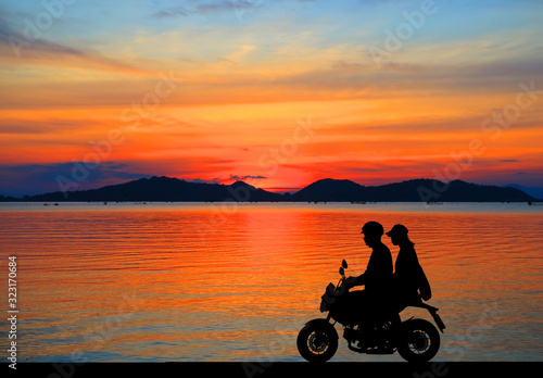 silhouette of lover couple in sunset with classic motorcycle © rathchapon