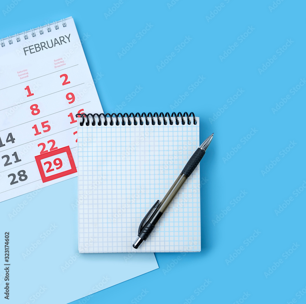 Calendar with marking in red pin of 29 february date. February month, calendar, notebook, pen. leap day in leap year concept. Calendar with marking in red pin of 29 february date. February month, calendar, notebook, pen. leap day in leap year concept.