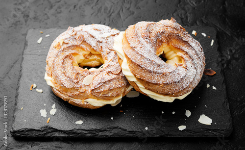 Obraz na płótnie Homemade choux pastry cake Paris Brest with almond flakes and sugar powder