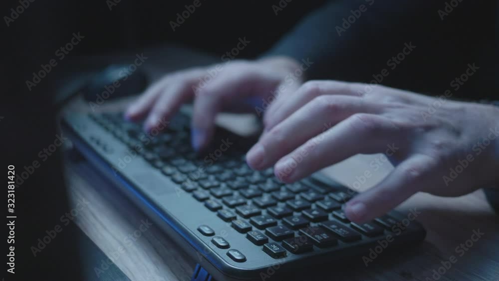 Close up shot of keyboard and man's hand typing, late at night. Close up shot of keyboard and man's hand typing, late at night.