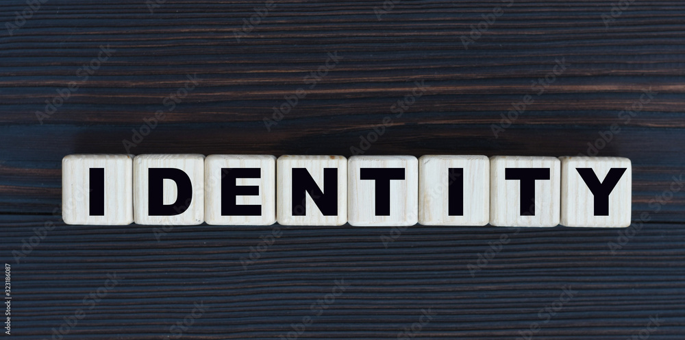 Obraz premium concept word identity on cubes on a beautiful dark wooden background