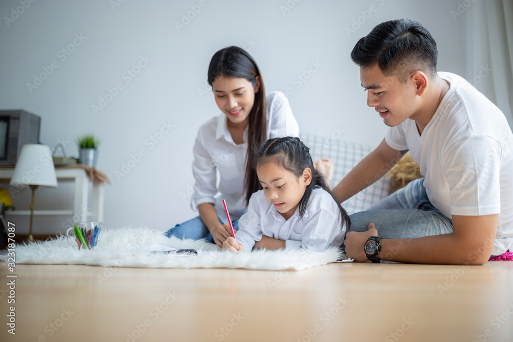 Young family drawing together with colorful pencils at home Young family drawing together with colorful pencils at home