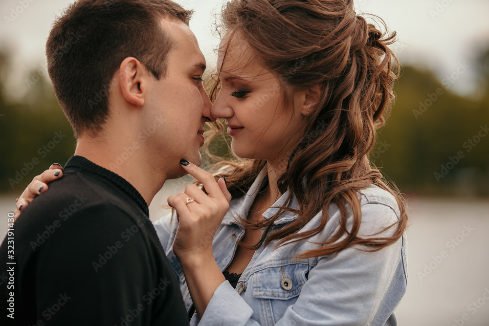 Fototapeta premium Young beautiful couple walking along the waterfront / Lifestyle
