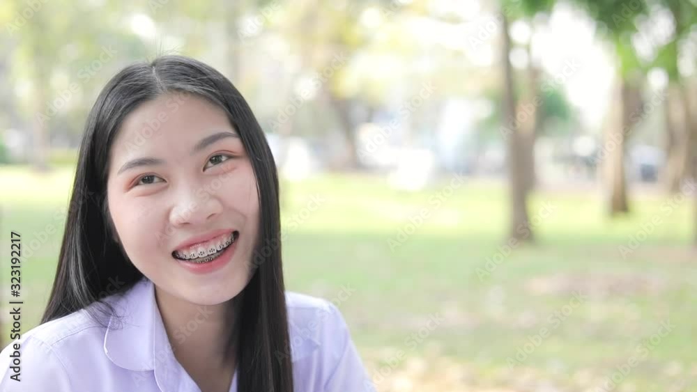 The smiling faces of teenage students.