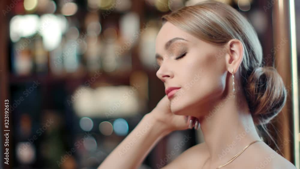 Seductive woman with evening makeup at light bokeh background. Wide shot on RED camera Seductive woman with evening makeup at light bokeh background. Wide shot on RED camera