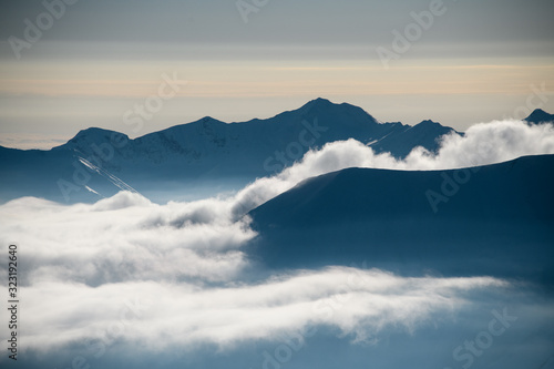Mountain tops peeking out from the clouds