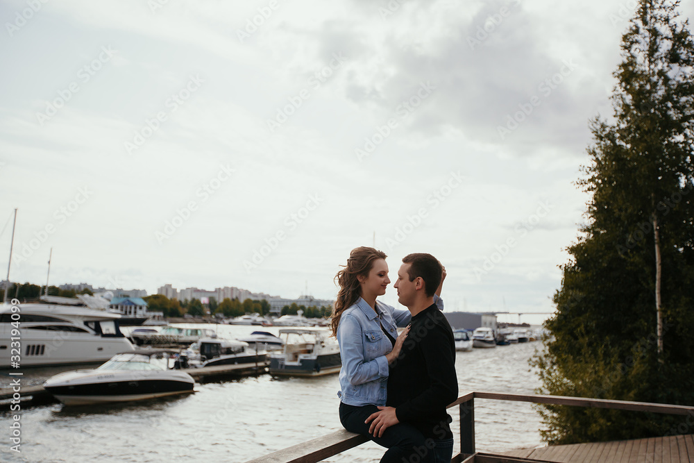 Young beautiful couple walking along the waterfront / Lifestyle
