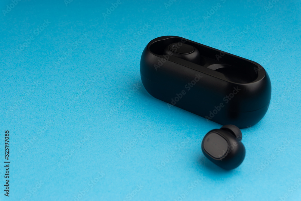 Wireless earbuds or earphones on blue background