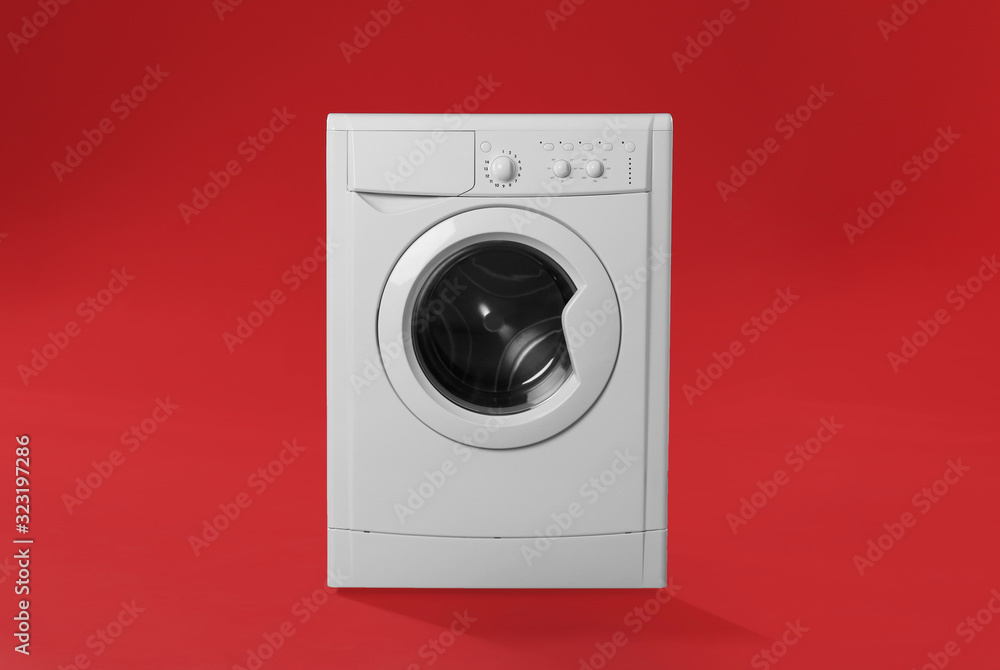 Modern washing machine on red background. Laundry day Modern washing machine on red background. Laundry day